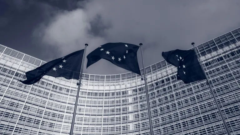 Photo by Christian Lue for Unsplash - EU Flags in front of the European Commission building in Brussels, Belgium