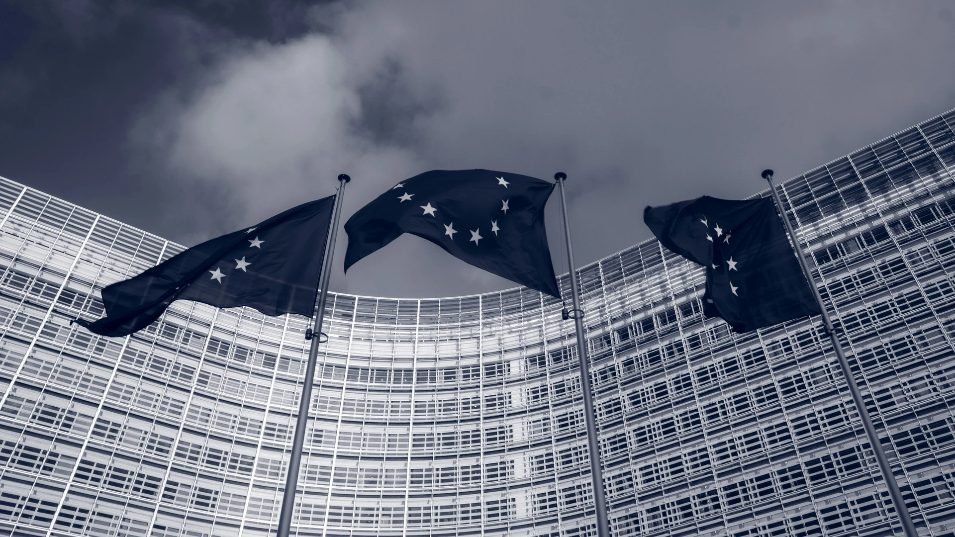 Photo by Christian Lue for Unsplash - EU Flags in front of the European Commission building in Brussels, Belgium